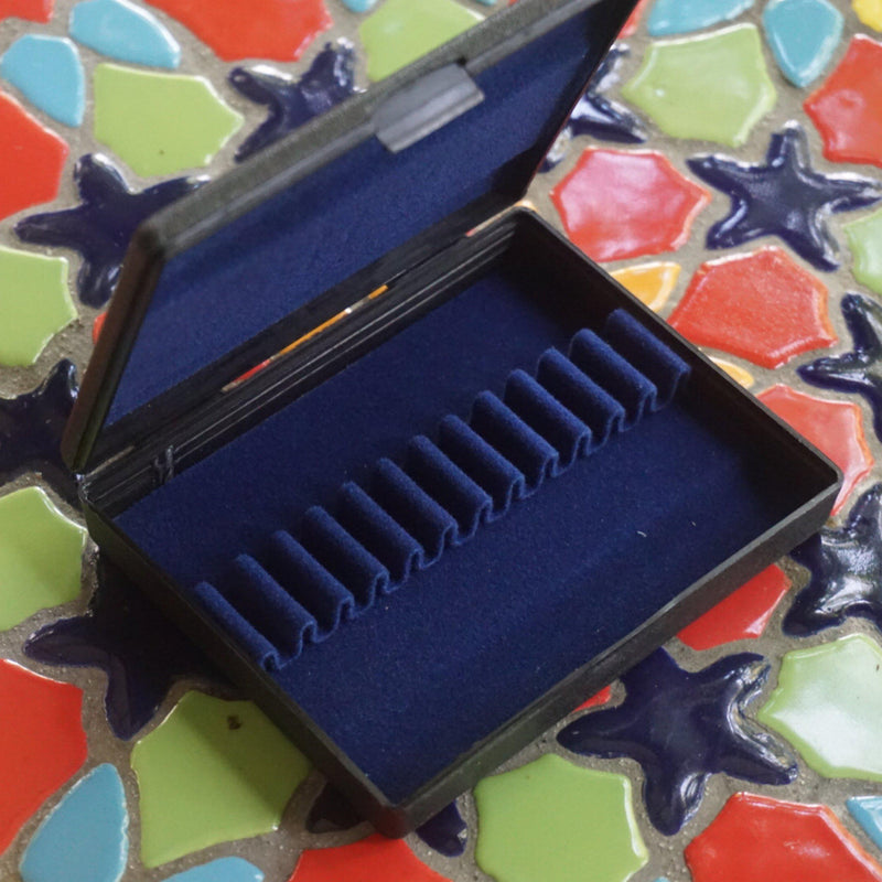 plastic oboe reed case that holds twelve oboe reeds. blue ribbons hold your best oboe reeds firmly in place 