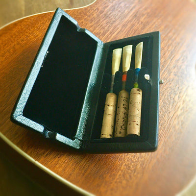 feux leather oboe reed case, pictured open with three oboe reeds