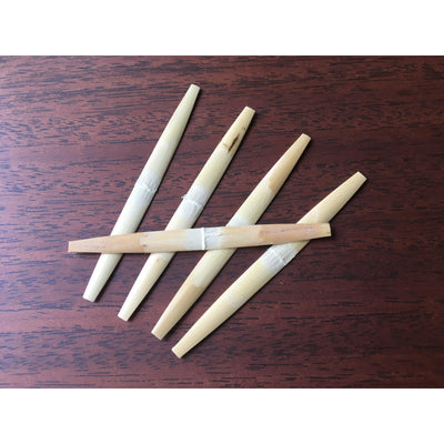 Profiled oboe cane, gouged, shaped, and folded, ready to be made into your best oboe reeds